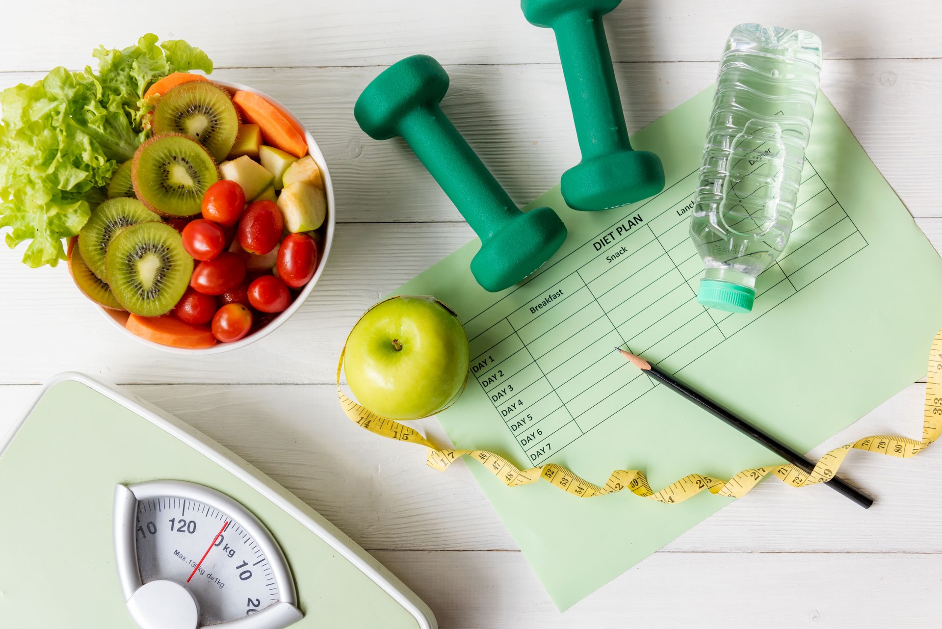 Diet Health Plan. start up workout planning. Sport exercise equipment workout and gym with nutrition fresh salad and green apple for fitness style. Healthy Lifestyle Concept, top view